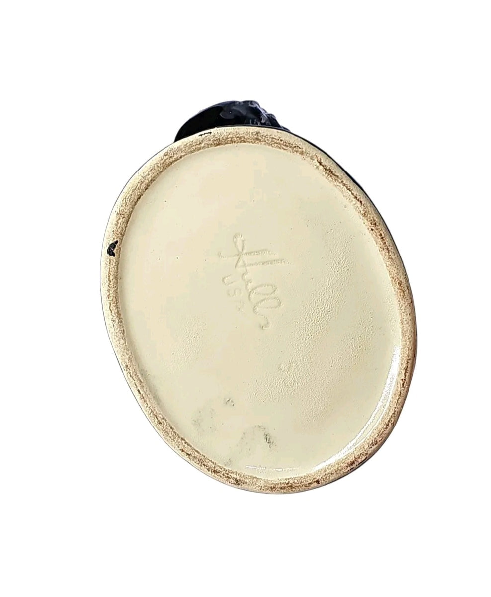 Oddly Darling Vintage Hull Pottery rooster planter base showing the embossed maker mark on the cream ceramic bottom