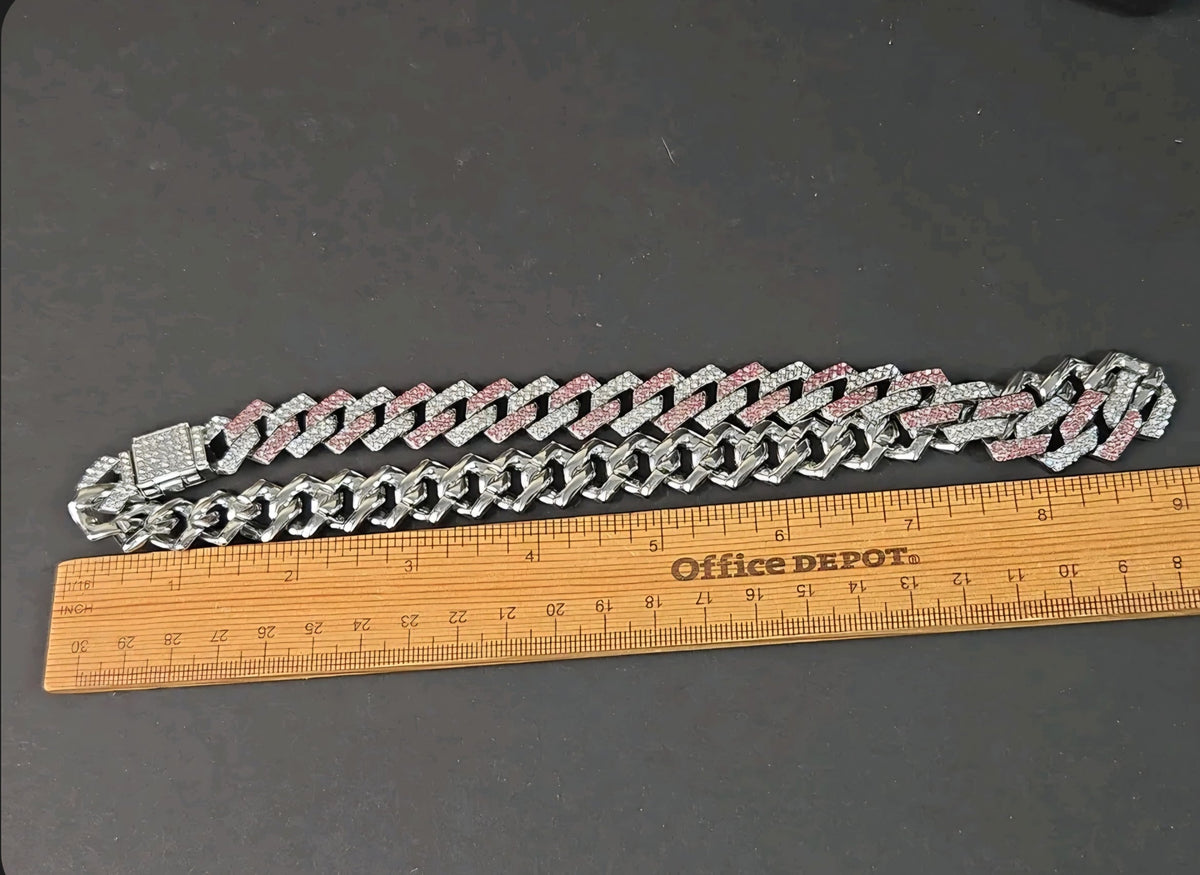 Oddly Darling Vintage iced-out cuban link necklace with alternating clear and pink stones on a dark background