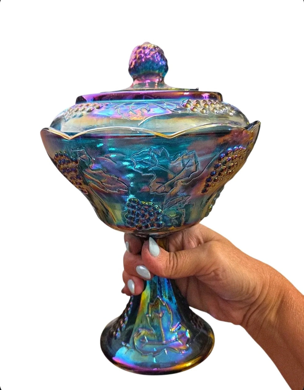 Oddly Darling Vintage iridescent carnival glass pedestal candy dish with lid featuring an embossed grape vine motif.