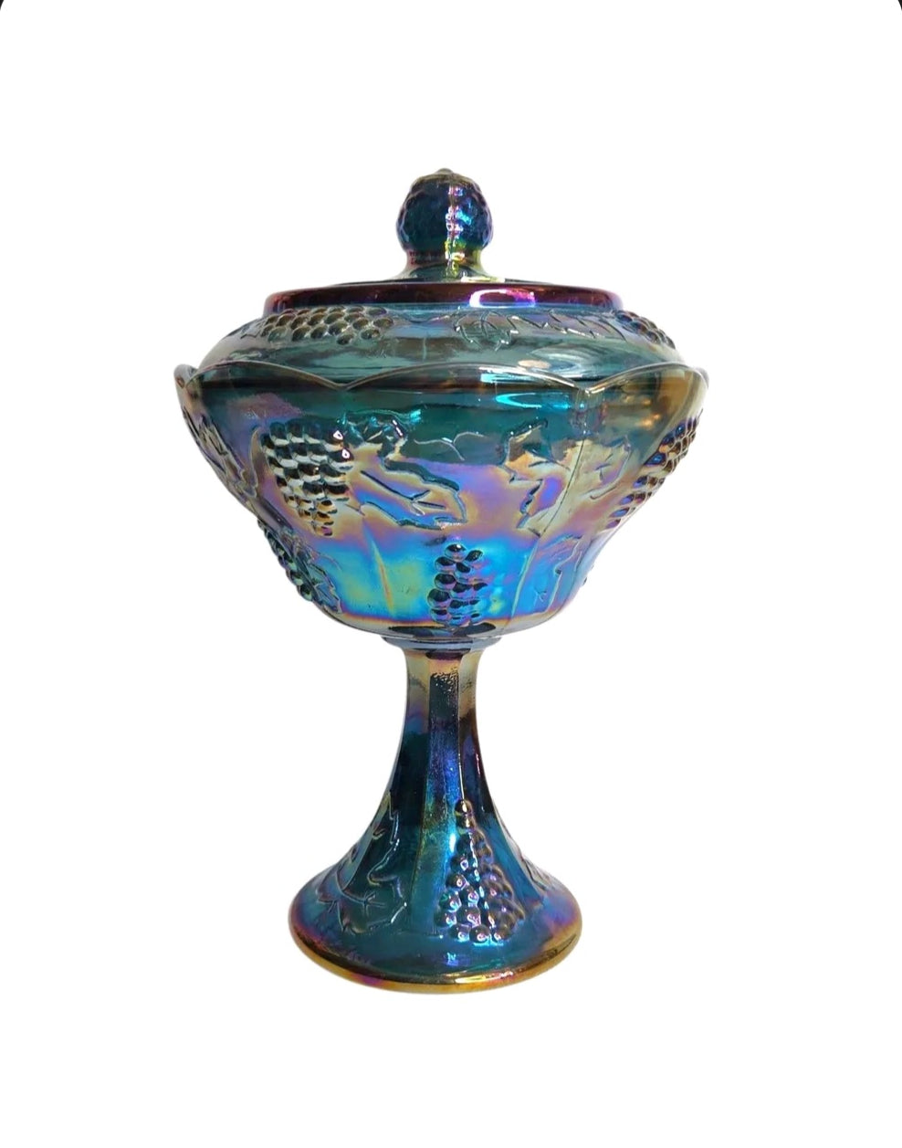 Oddly Darling Vintage iridescent blue carnival glass pedestal candy dish with embossed grape and vine motif and lid.