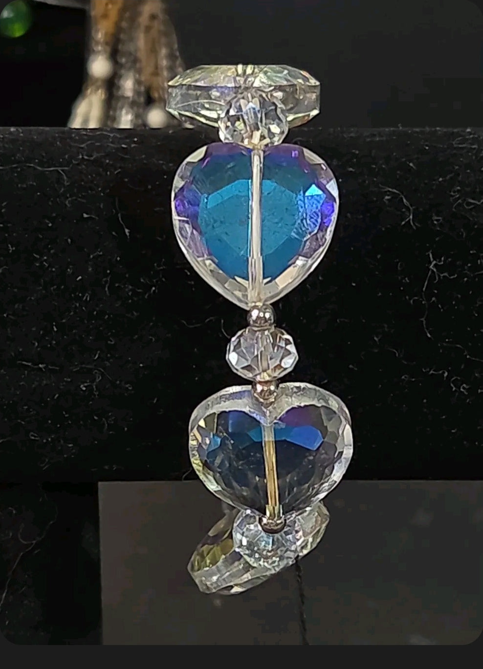 Oddly Darling Vintage stretch bracelet featuring iridescent faceted heart beads with blue and purple aurora reflections