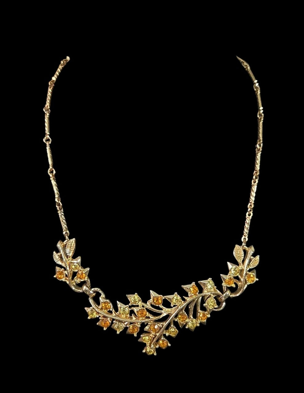 Oddly Darling Vintage gold-tone statement necklace featuring intricate leaf motifs and amber and yellow crystals.