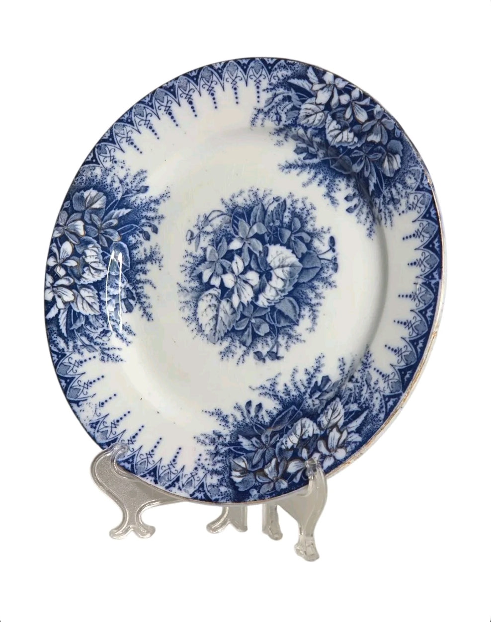 Oddly Darling Vintage Lunéville ceramic plate featuring a blue floral transferware pattern on an off-white background.
