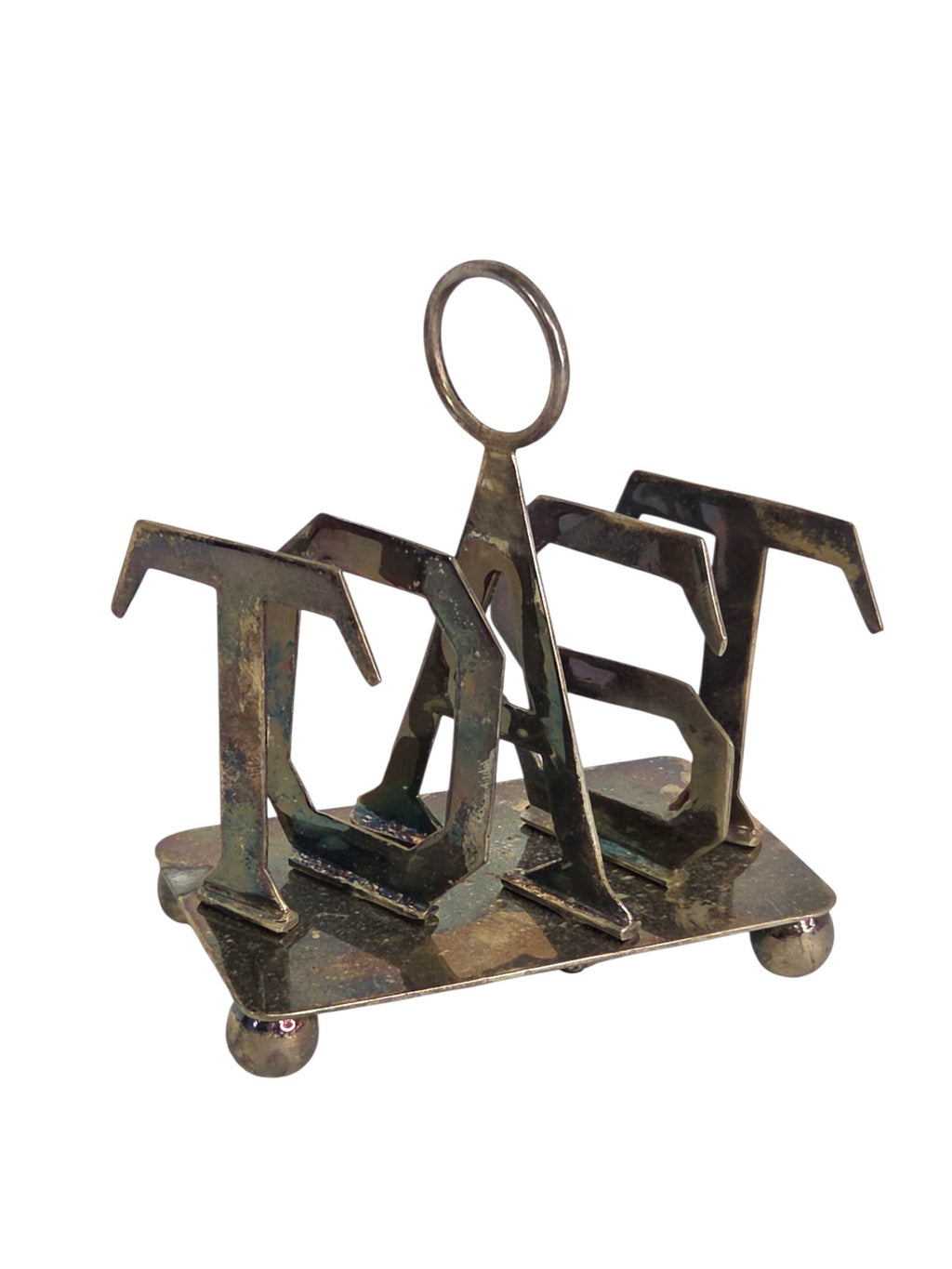 Oddly Darling Vintage metal toast rack with sculptural TOAST lettering, central ring handle, and ball feet.