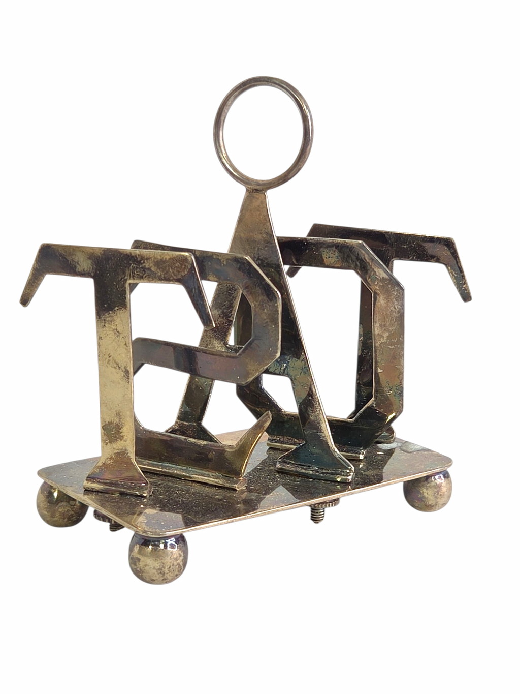 Oddly Darling Vintage metal toast rack with a sculptural TOAST letter design, central handle, and ball feet.