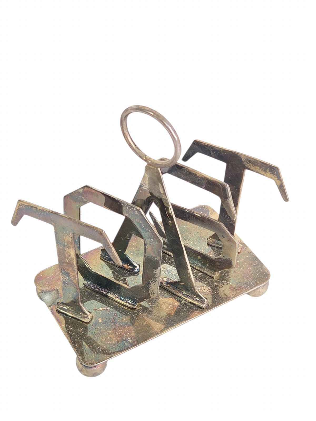Oddly Darling Vintage metal toast rack with sculptural TOAST lettering, central ring handle, and ball-style feet.