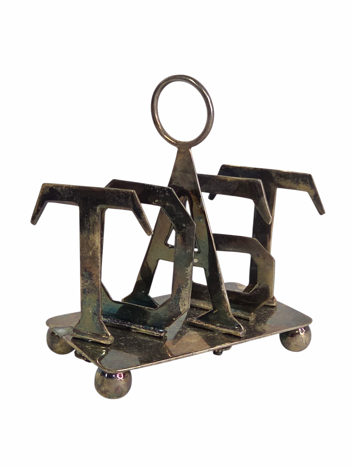 Oddly Darling Vintage metal toast rack with sculptural TOAST lettering and a central ring handle on ball feet.