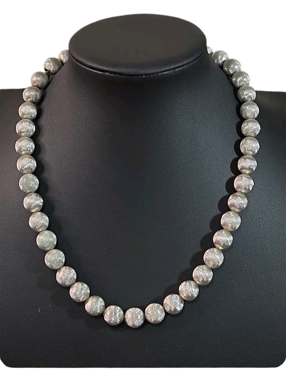 Oddly Darling Vintage Monet silver-tone statement necklace with textured spherical beads on a black display bust.