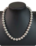 Oddly Darling Vintage Monet silver-tone statement necklace with textured spherical beads on a black display bust.