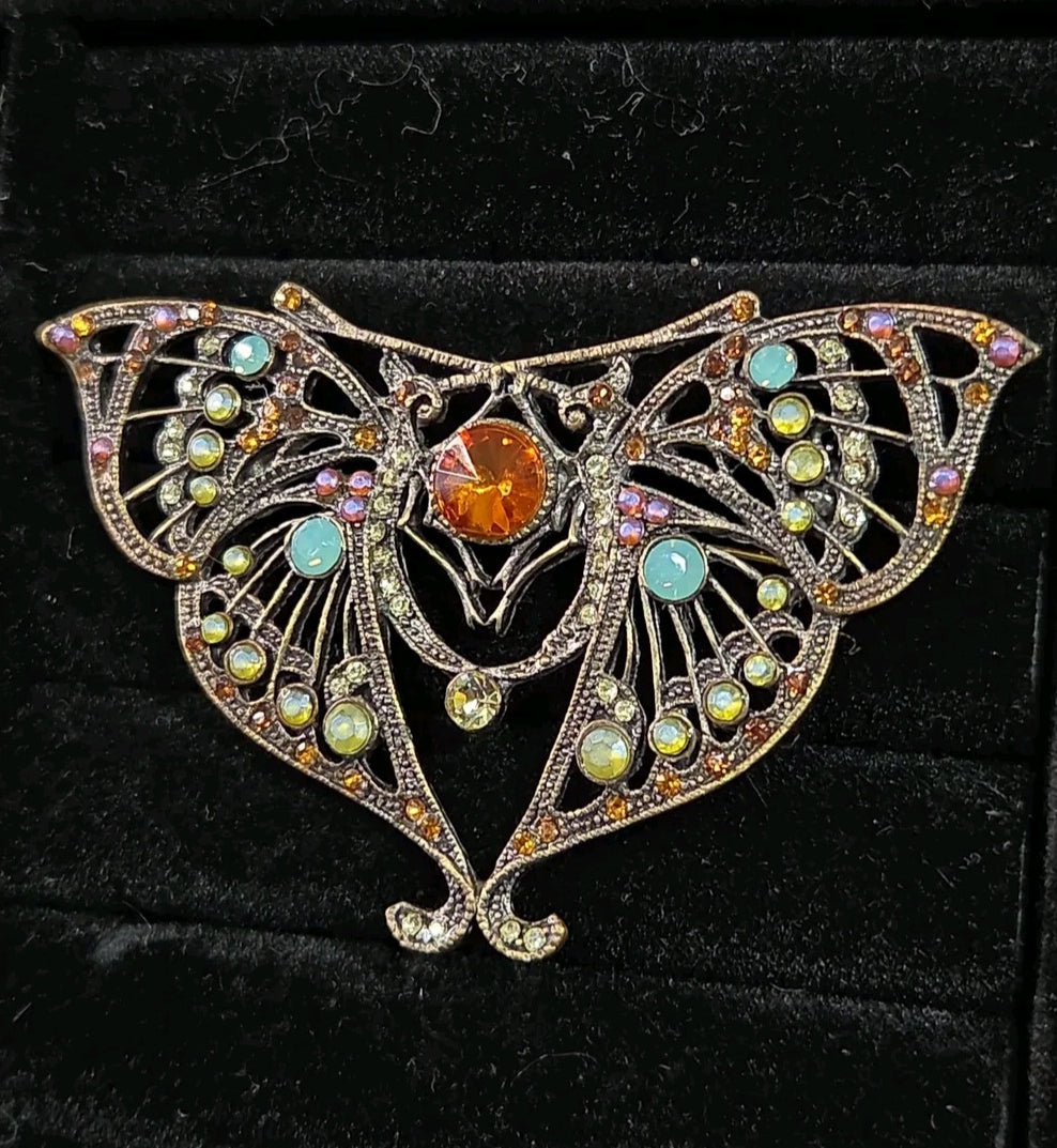 Oddly Darling Vintage ornate moth brooch in antique bronze with a central amber stone and multi-colored crystals.