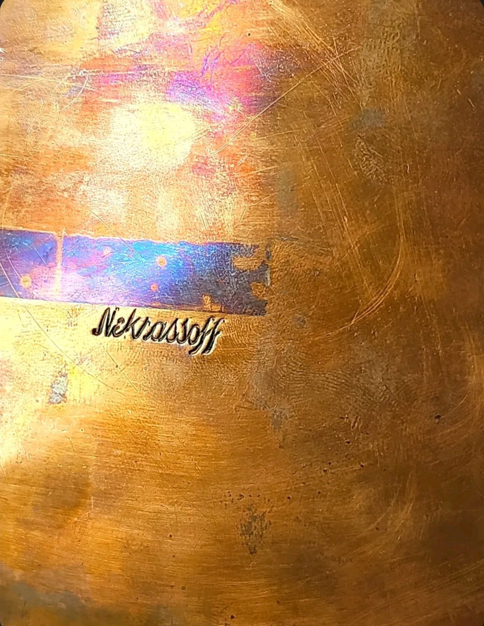 Oddly Darling Vintage Nekrassoff signature mark engraved on a warm copper metal surface with a subtle patina