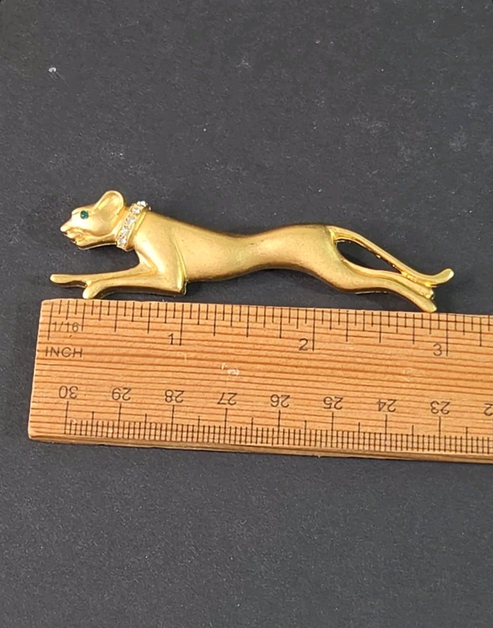 Oddly Darling Vintage panther brooch in brushed gold-tone with crystal collar and emerald green eye on a ruler