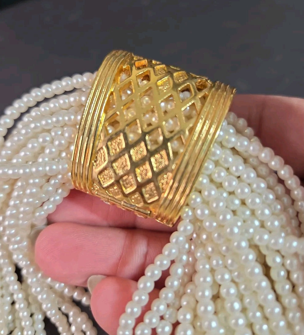Oddly Darling Vintage multi-strand cream faux pearl necklace with a gold-tone textured lattice clasp centerpiece.