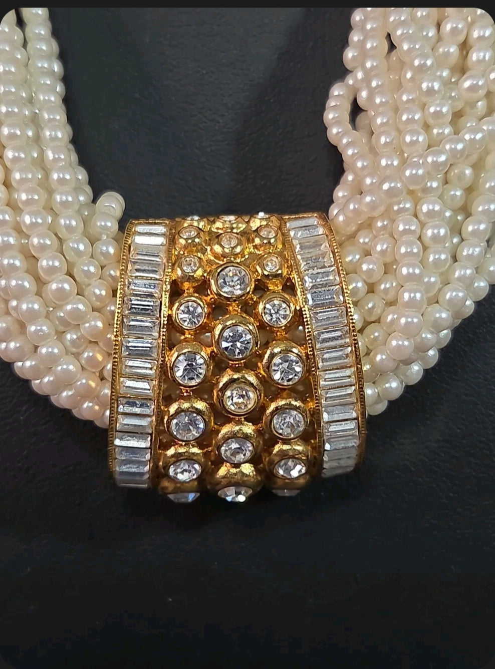 Oddly Darling Vintage multi-strand cream faux pearl necklace with a gold-tone rhinestone and crystal centerpiece.