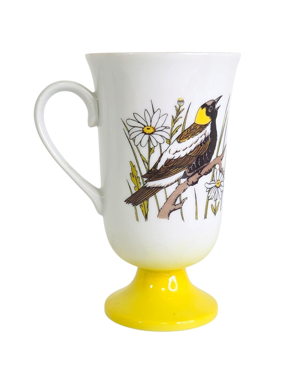 Oddly Darling Vintage pedestal mug featuring a songbird and daisy illustration on a white ceramic base with yellow foot