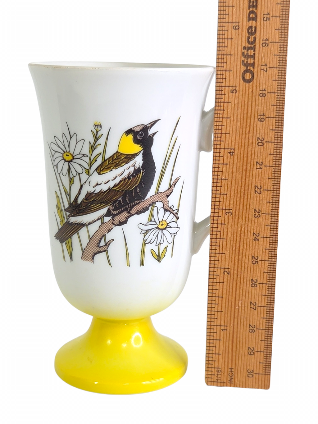 Oddly Darling Vintage pedestal mug with songbird and daisy illustration on a white ceramic body with yellow base