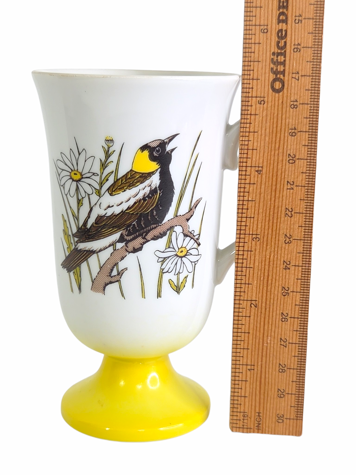 Oddly Darling Vintage pedestal mug with songbird and daisy illustration on a white ceramic body with yellow base