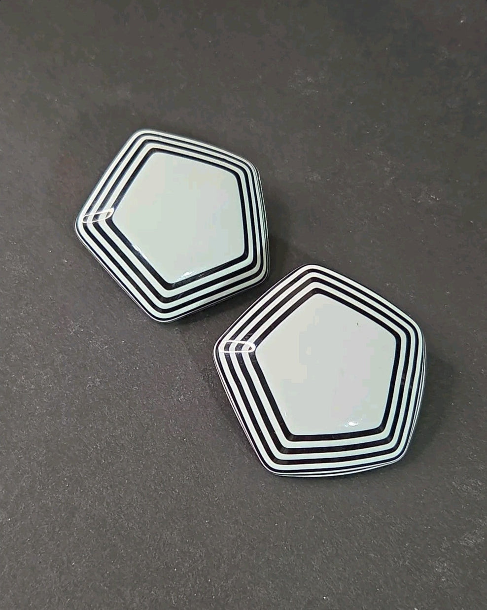 Oddly Darling Vintage pentagonal clip-on earrings with a glossy white center and black and white striped borders.