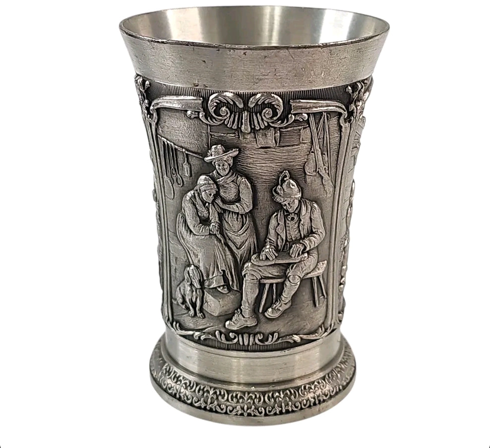 Oddly Darling Vintage SKS Zinn pewter beaker with intricate embossed rustic village scenes and antique metal finish.