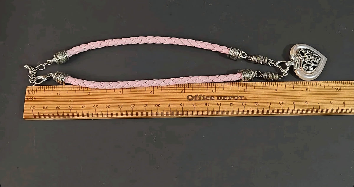 Oddly Darling Vintage heart pendant necklace with a braided light pink cord and silver filigree detailing.