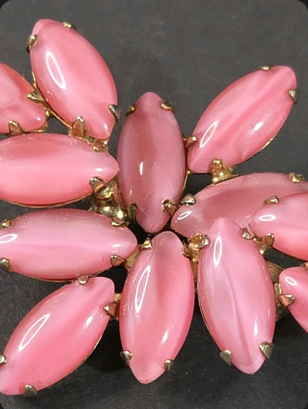 Oddly Darling Vintage brooch featuring a cluster of pastel pink marquise-cut cabochon stones in a gold-tone setting.