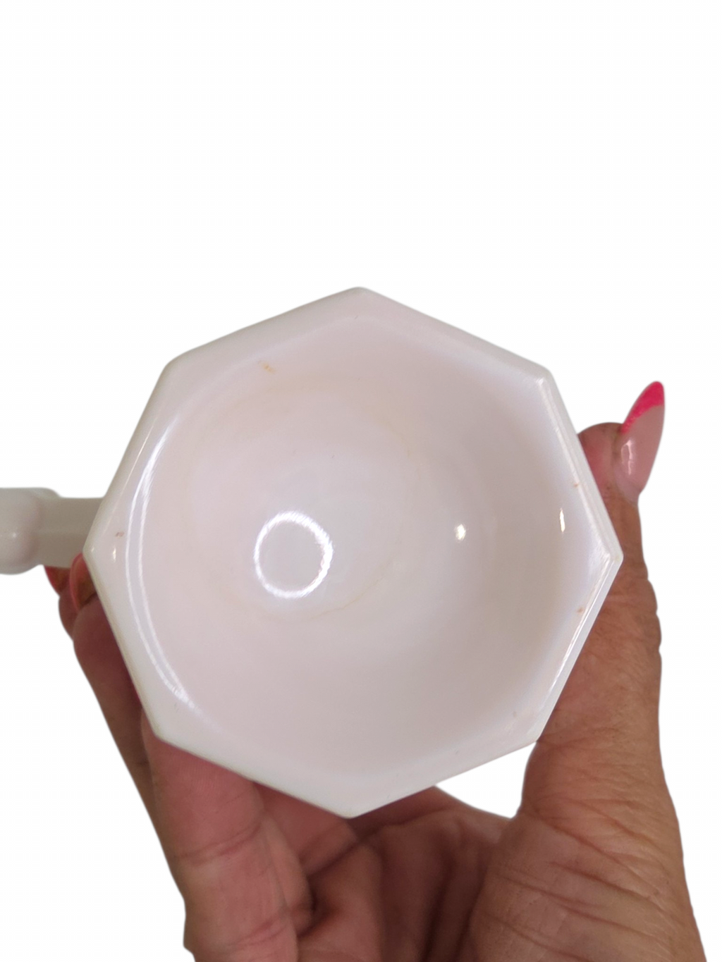 Oddly Darling Vintage pale pink milk glass creamer pitcher with a unique hexagonal rim held in a hand
