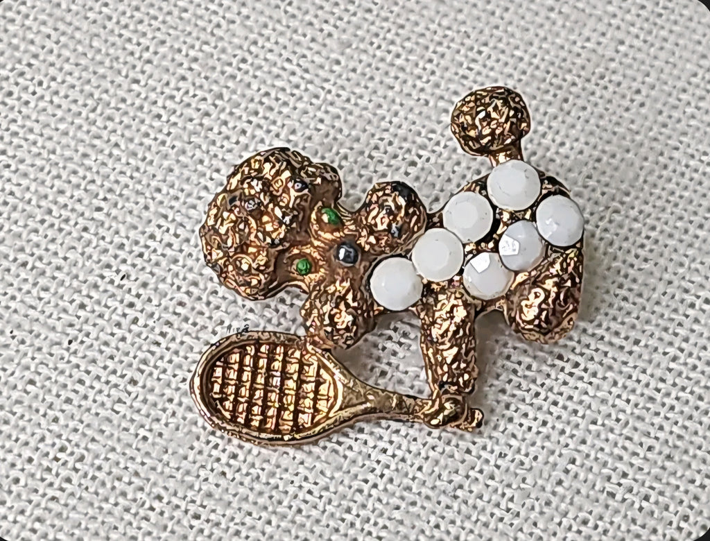 Oddly Darling Vintage gold-tone poodle brooch with white milk glass stones and a miniature tennis racket.