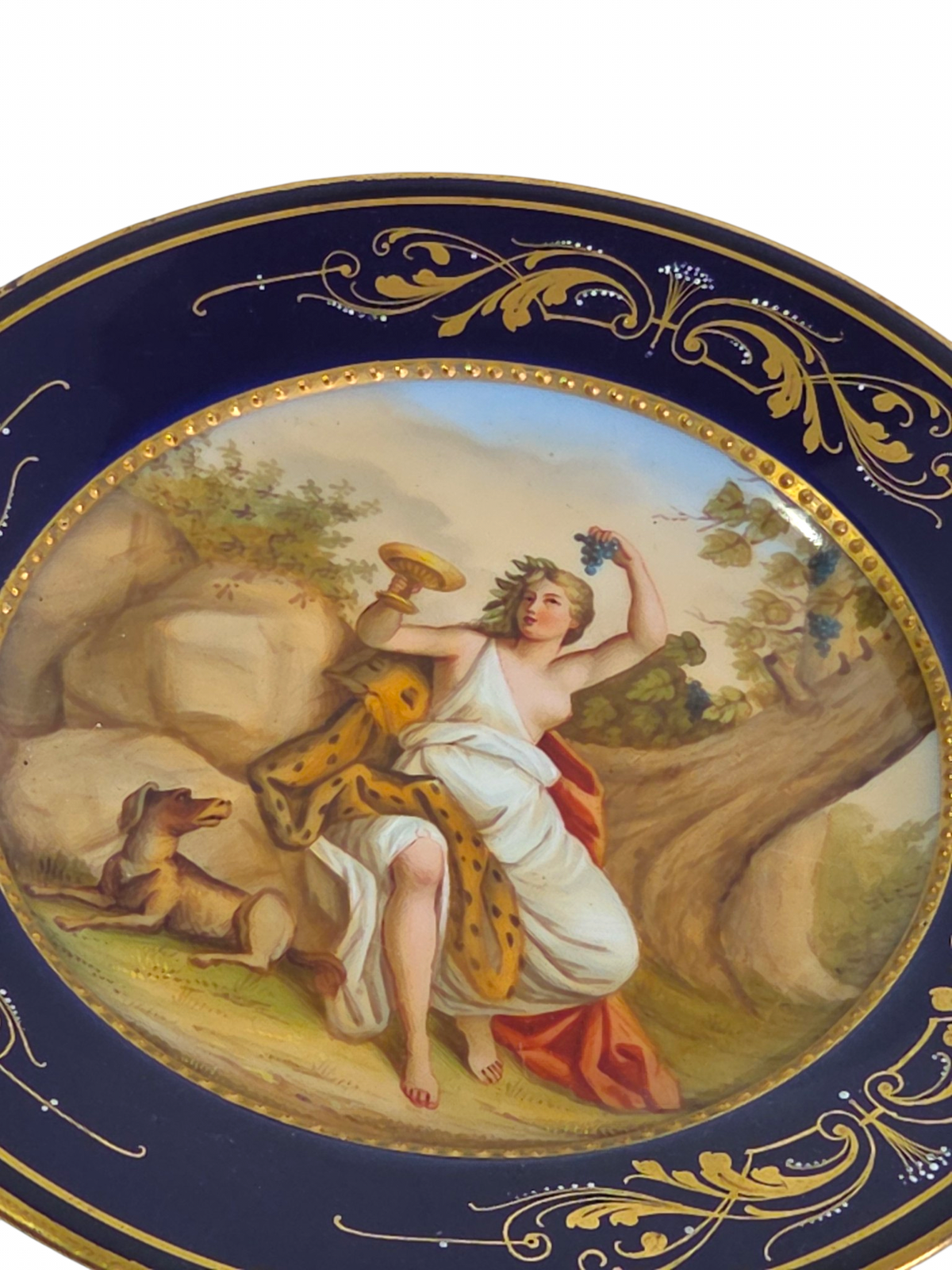 Oddly Darling Vintage porcelain display plate featuring a hand-painted mythological scene with gold-gilt cobalt border.