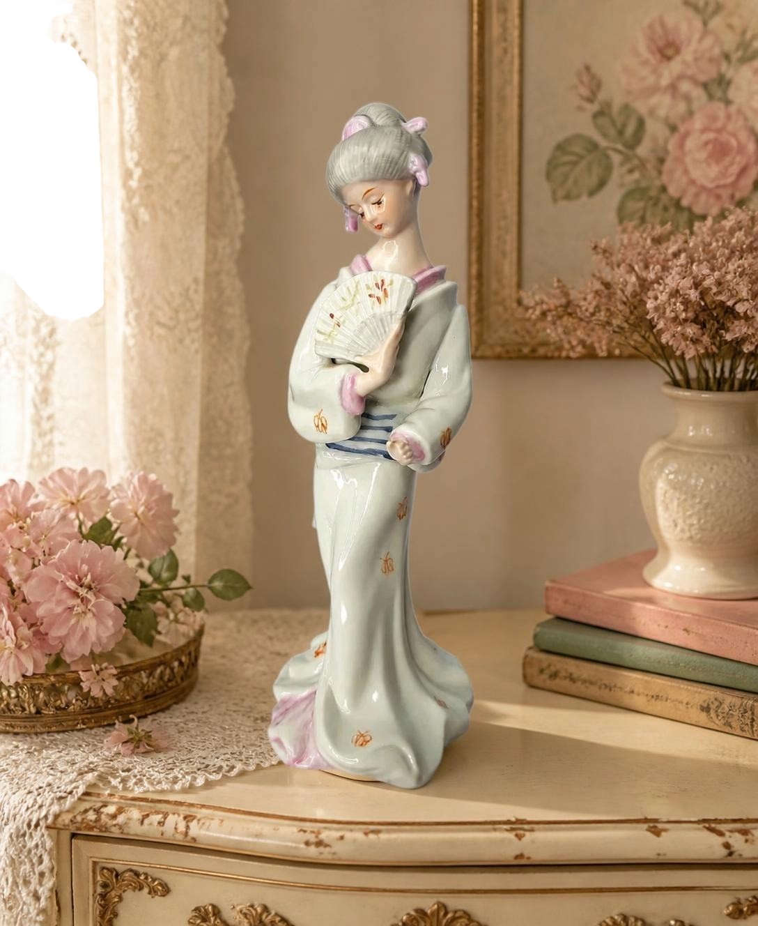Oddly Darling Vintage porcelain geisha figurine wearing a pale blue kimono with hand-painted details and a fan.