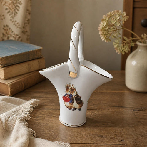 Oddly Darling Vintage white porcelain basket vase featuring Peter Rabbit and Benjamin Bunny with gold-tone trim.