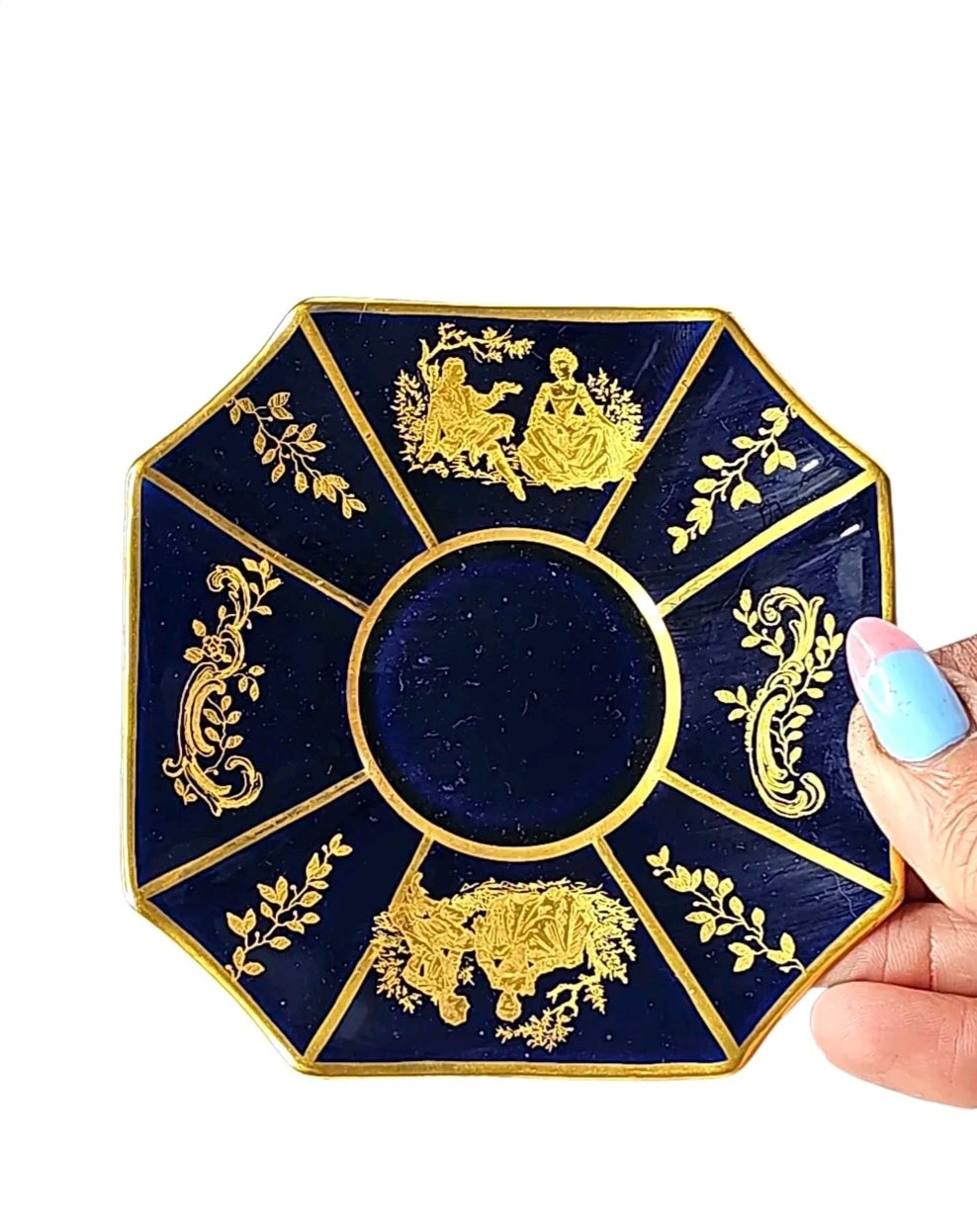 Oddly Darling Vintage Rosenthal octagonal porcelain saucer in cobalt blue with intricate gold-leaf romantic scenes.
