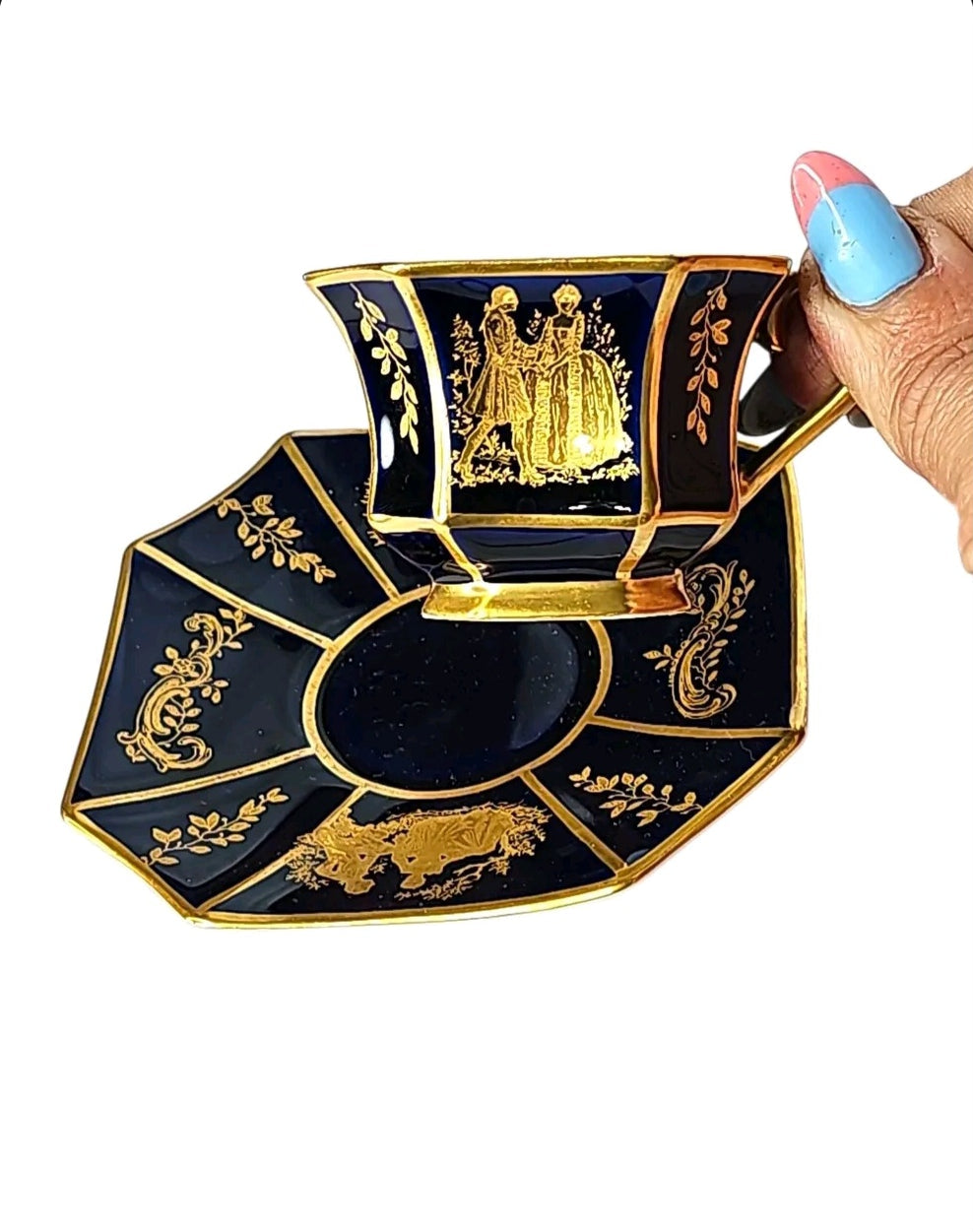 Oddly Darling Vintage Rosenthal octagonal porcelain teacup and saucer in cobalt blue with intricate gold-leaf scenes.