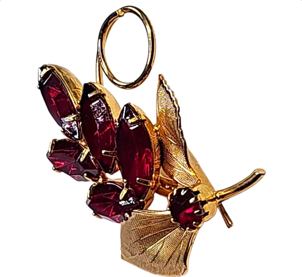 Oddly Darling Vintage brooch featuring ruby-red marquise crystals and textured gold-tone leaves in a floral design.