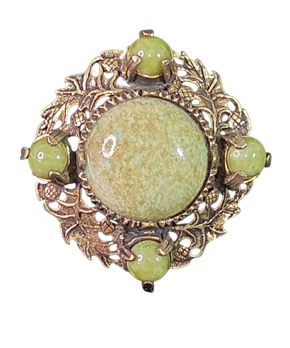 Oddly Darling Vintage brooch featuring a sage-green mottled cabochon in an antique-gold leaf and acorn metal frame.