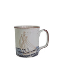 Oddly Darling Vintage ceramic coffee mug with a sailboat illustration, speckled off-white finish, and brown rim.