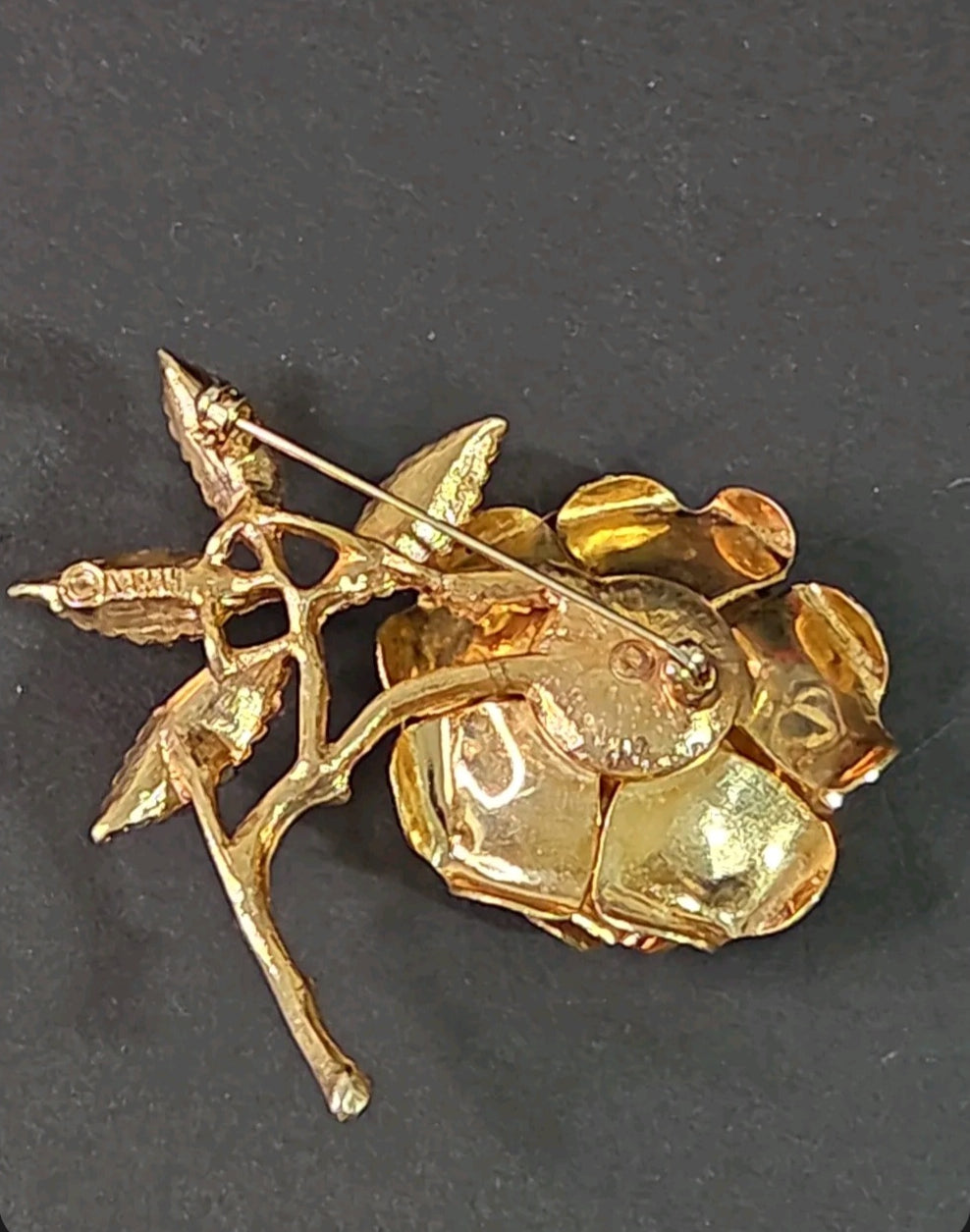 Back view of an Oddly Darling Vintage SARAH gold-tone rose brooch showing the pin mechanism and textured metal finish.