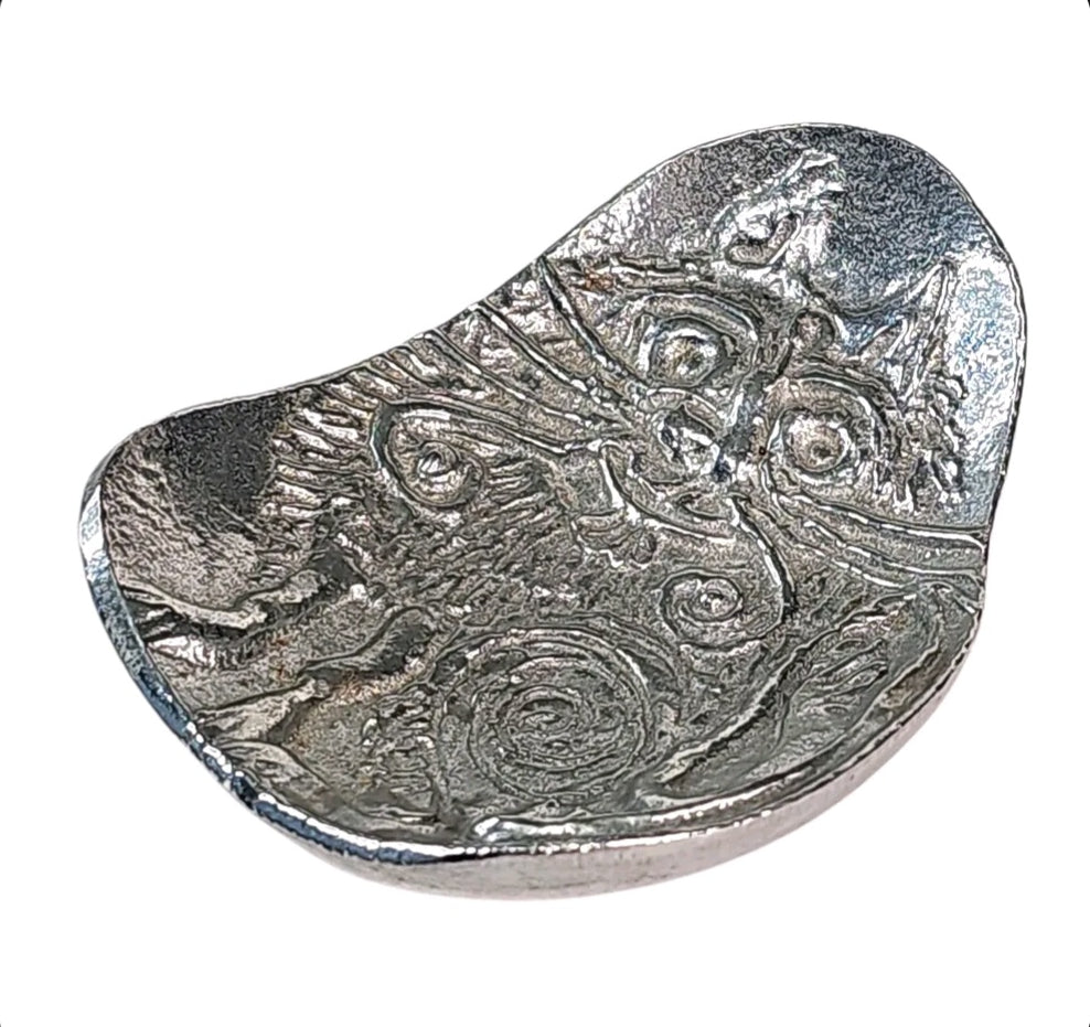 Oddly Darling Vintage silver cast aluminum trinket dish featuring an embossed cat design with artistic swirl details.