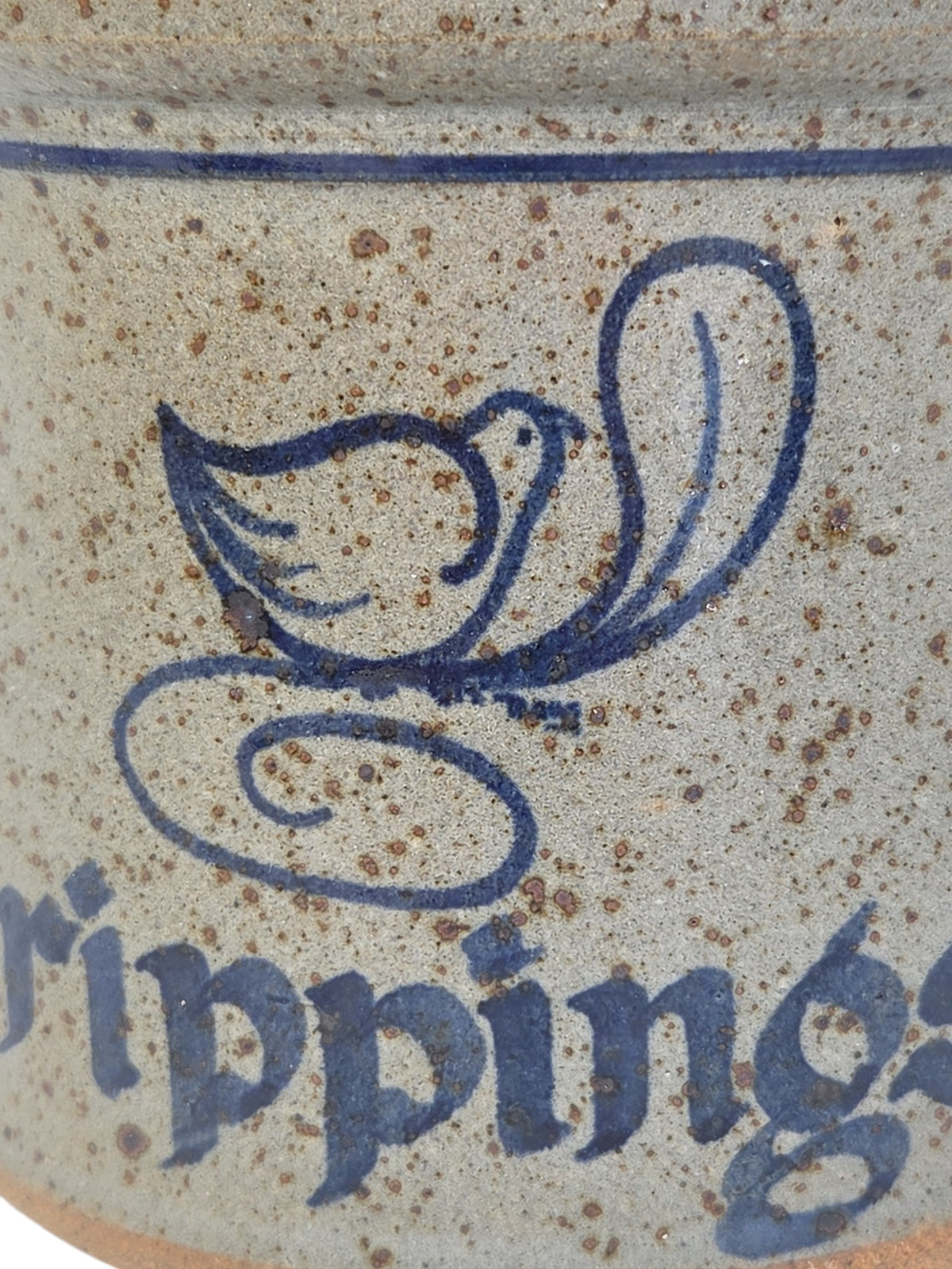 Oddly Darling Vintage speckled stoneware crock featuring a blue bird motif and the word Drippings in script