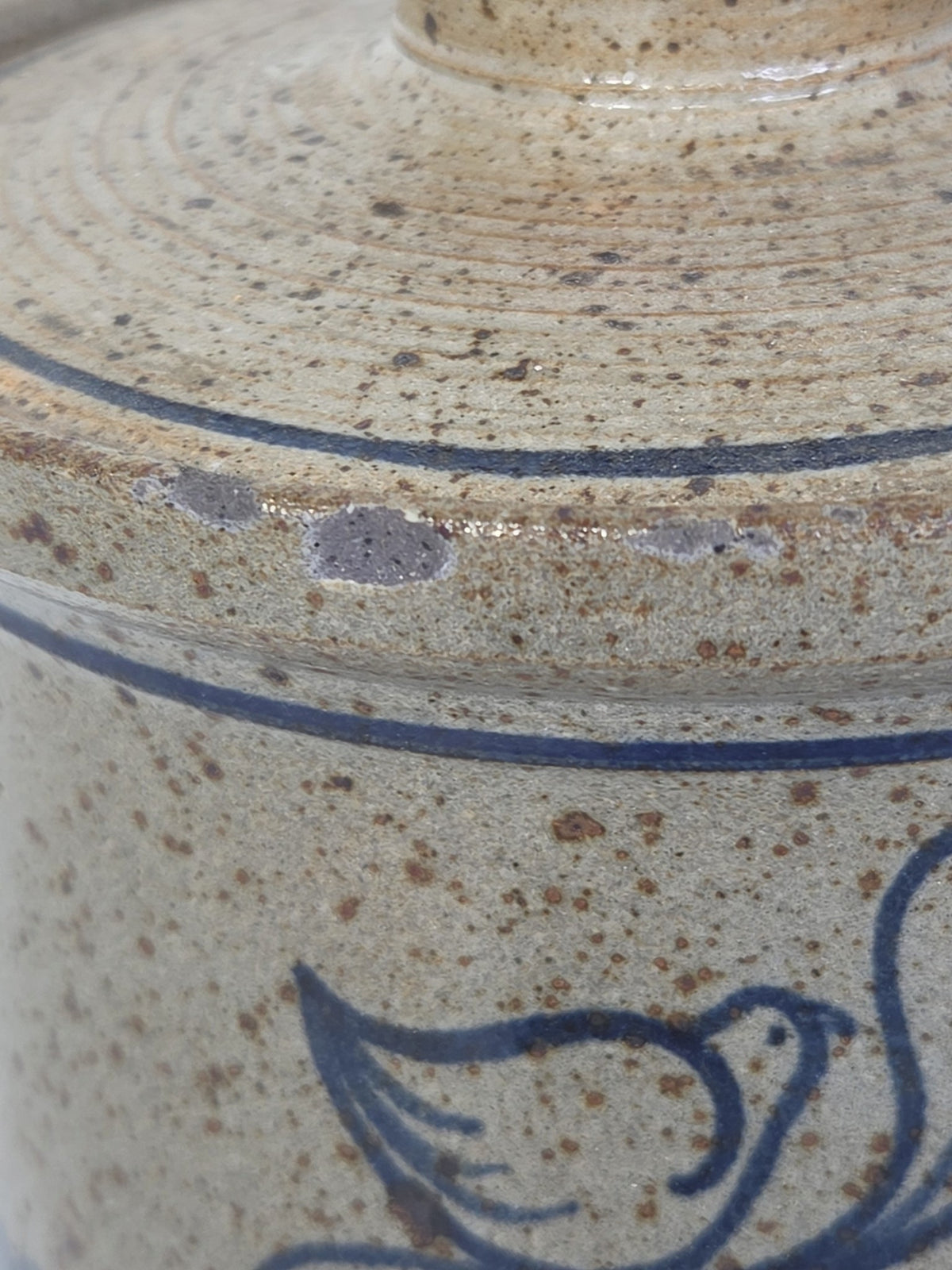 Oddly Darling Vintage speckled stoneware kitchen crock with a blue bird motif and lid in a rustic farmhouse style.
