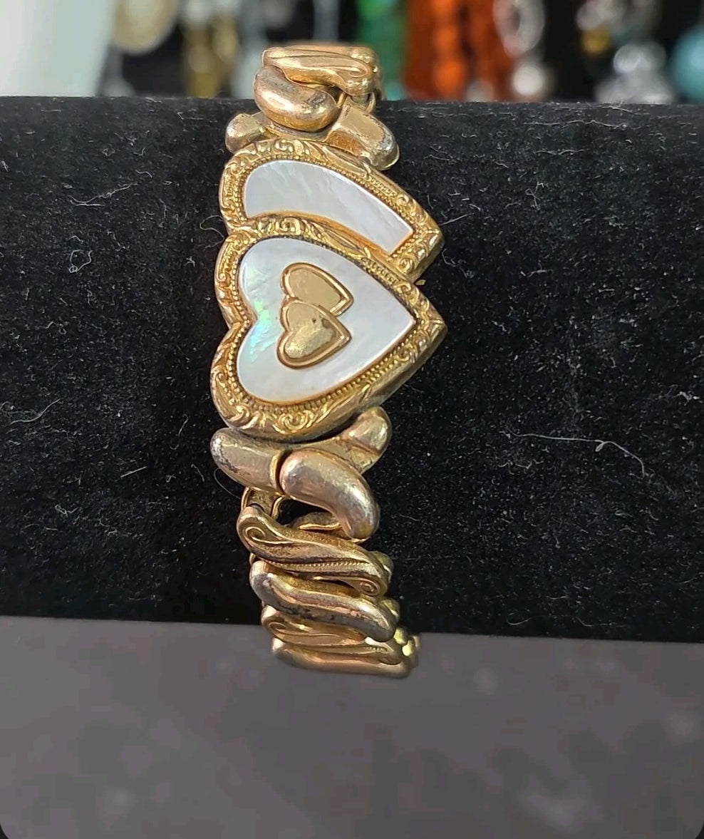 Oddly Darling Vintage Speidel gold-tone expansion bracelet featuring dual heart motifs with mother-of-pearl inlays.