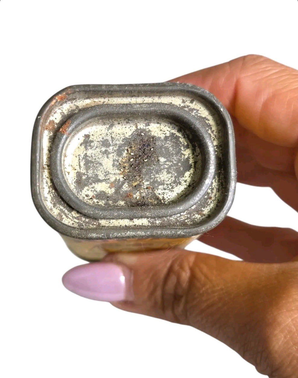 Oddly Darling Vintage Sudan Brand celery seed tin base showing weathered metal patina held by a hand