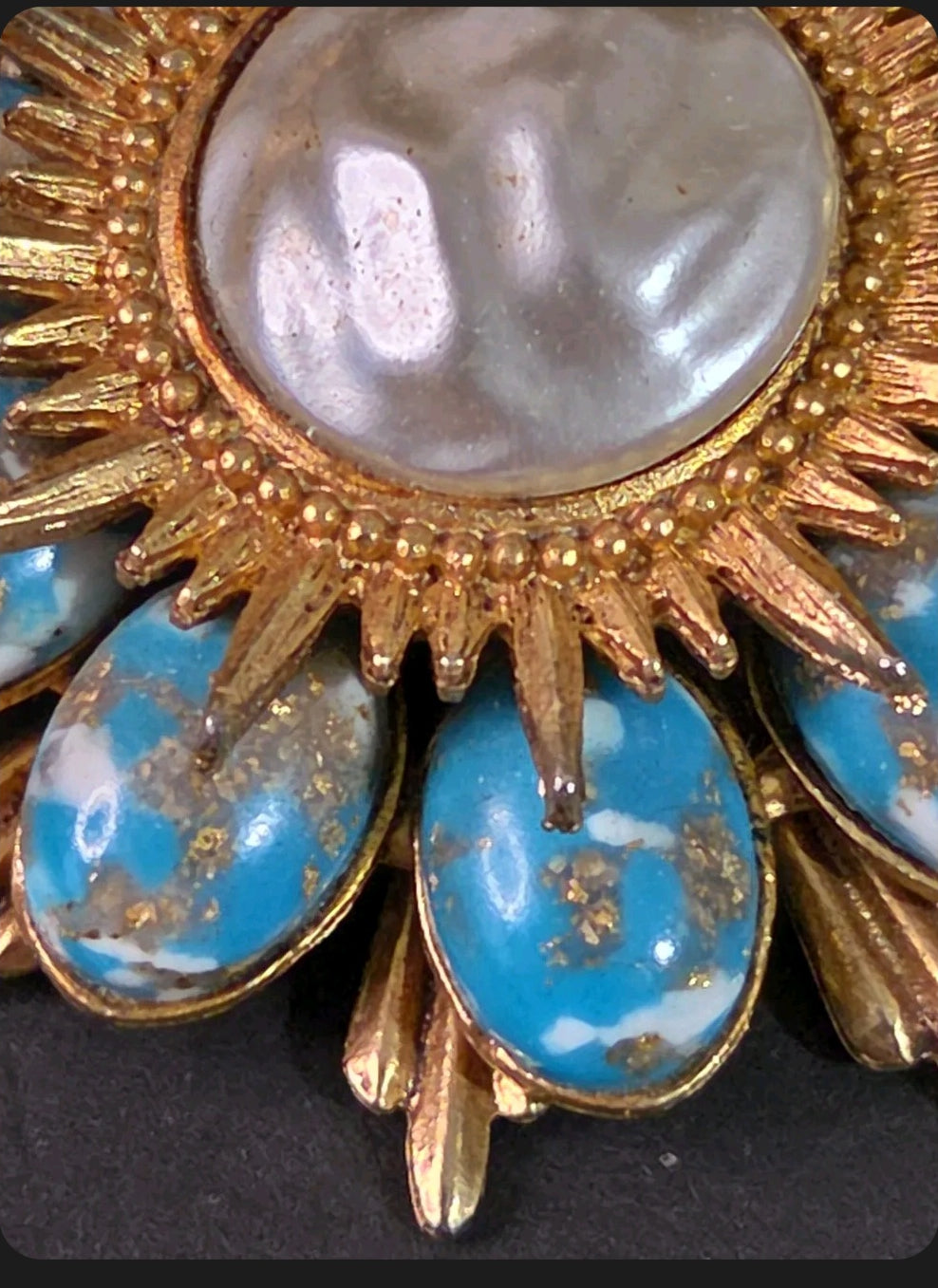 Oddly Darling Vintage sunburst brooch with a central cabochon and oval turquoise stones with gold flecks.