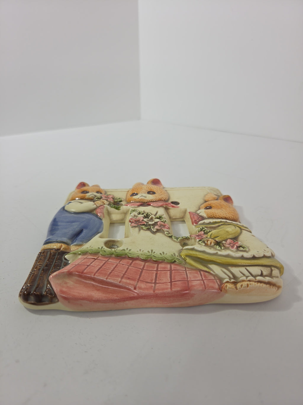 Oddly Darling Vintage Takahashi ceramic double light switch plate featuring a raised relief of three dressed bunnies.