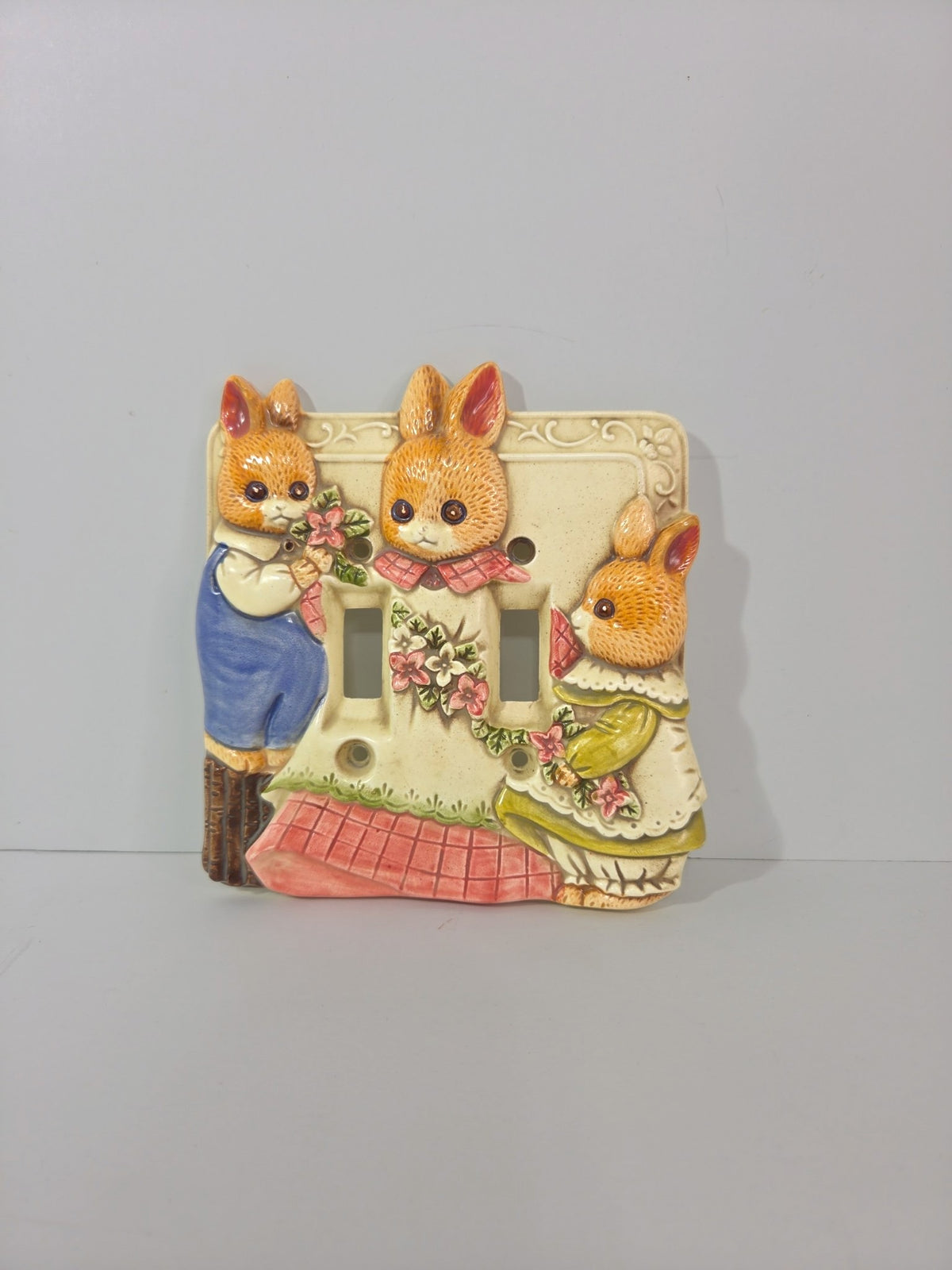 Vintage Takahashi ceramic double light switch plate with three dressed bunnies in raised relief