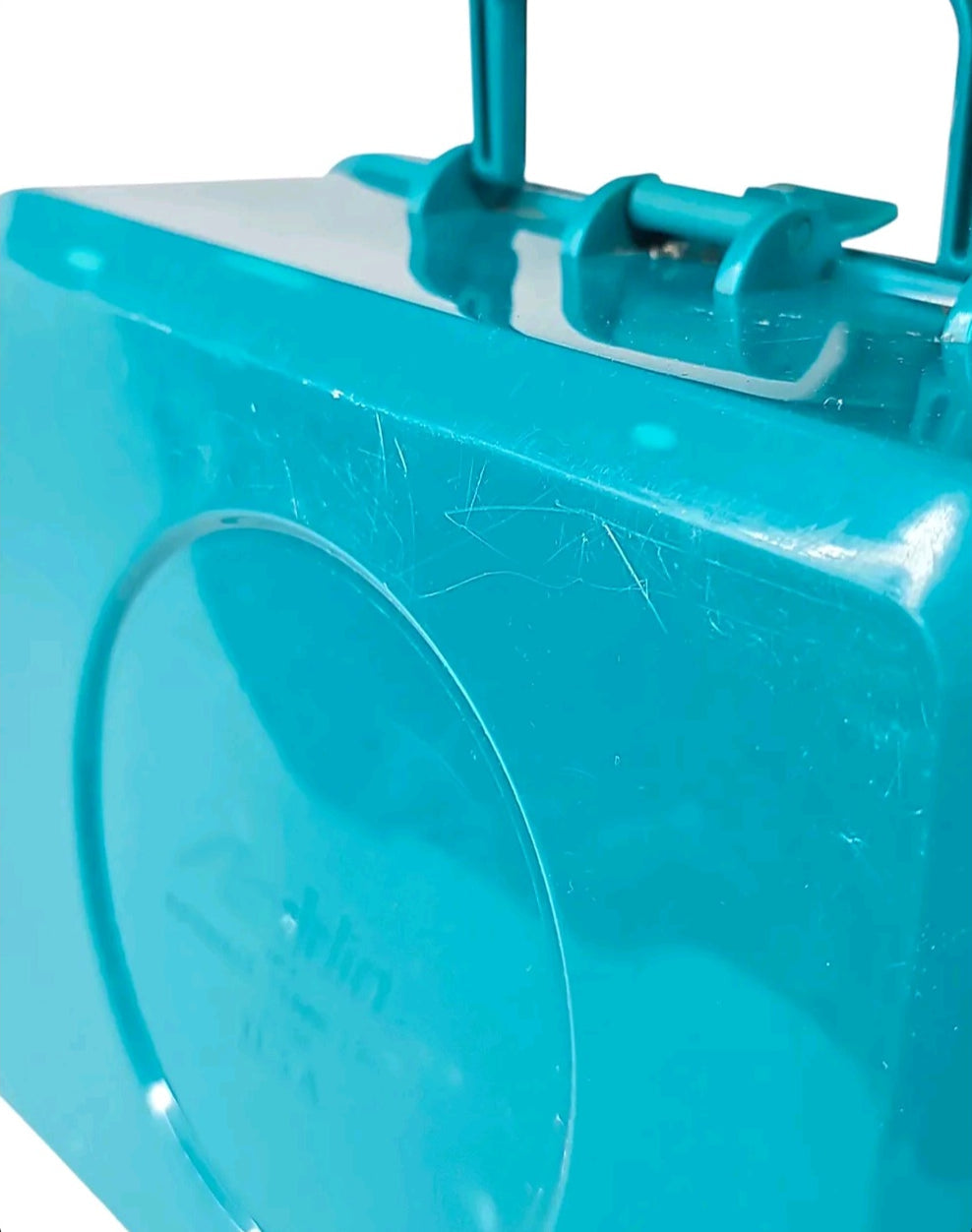Oddly Darling Vintage teal plastic lunchbox with handle and latch, showing light surface wear on the exterior.