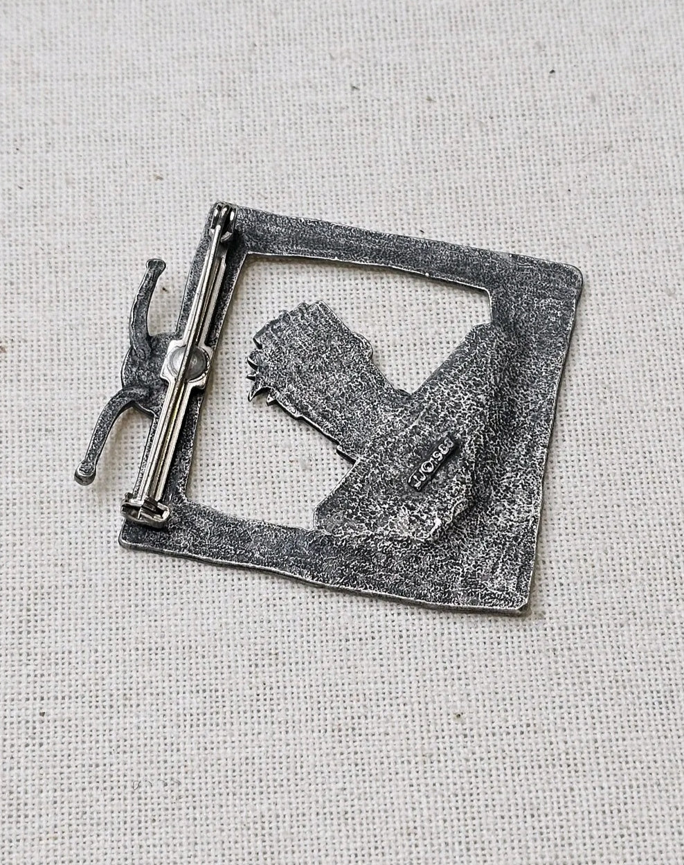 Oddly Darling Vintage silver-tone metal brooch featuring a retro television frame with a character silhouette back view