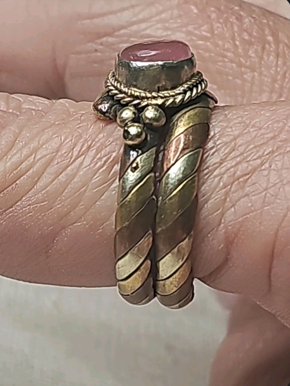 Oddly Darling Vintage twisted metal band ring with a pink cabochon stone, rope-style detailing, and bead accents.