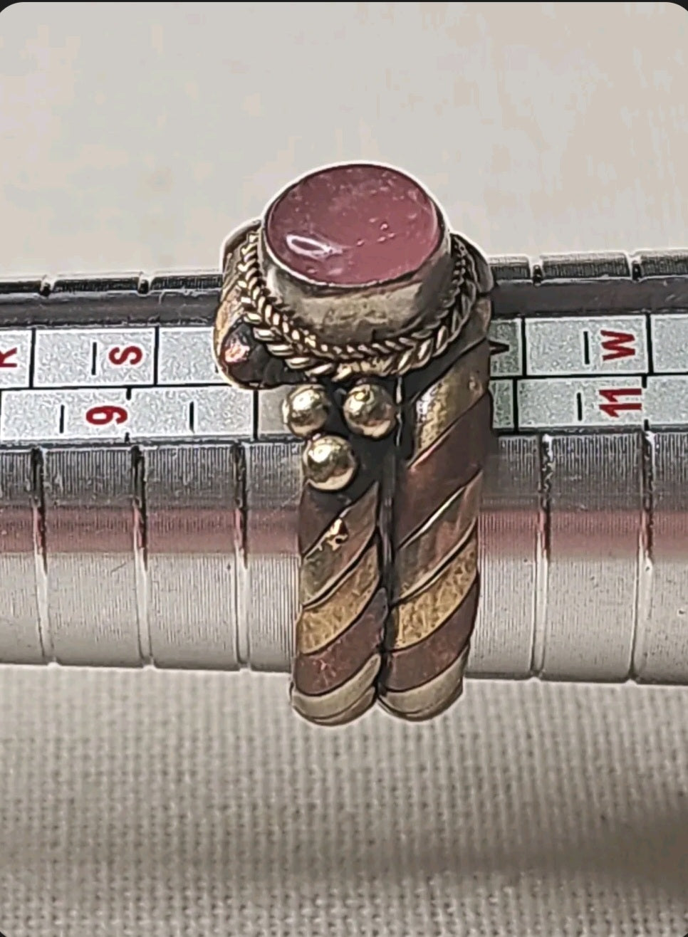 Oddly Darling Vintage twisted metal ring with a pink cabochon stone, rope detailing, and copper and brass accents.