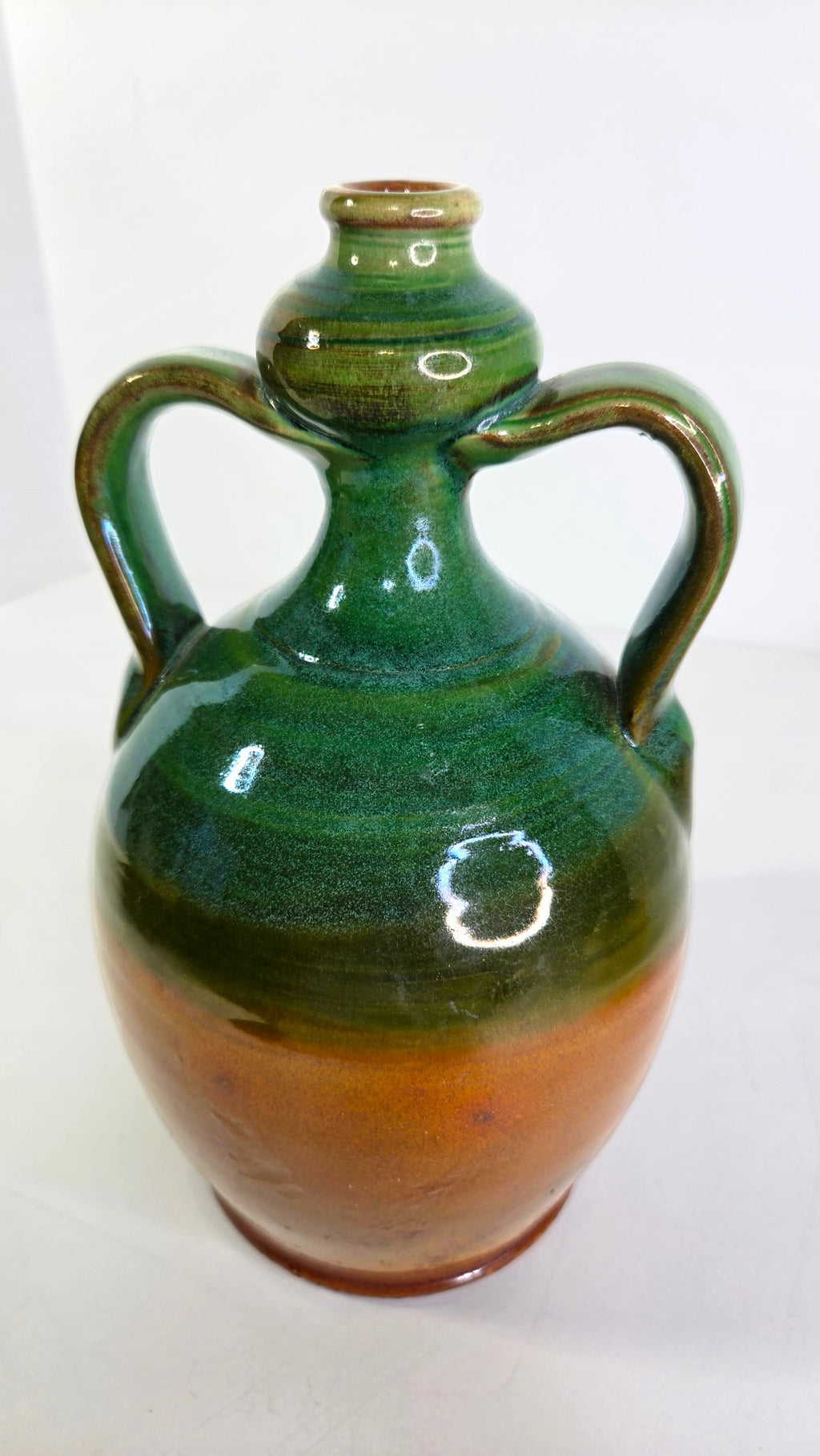 Oddly Darling Vintage handcrafted ceramic jug with two handles, featuring a two-tone forest green and amber glaze.