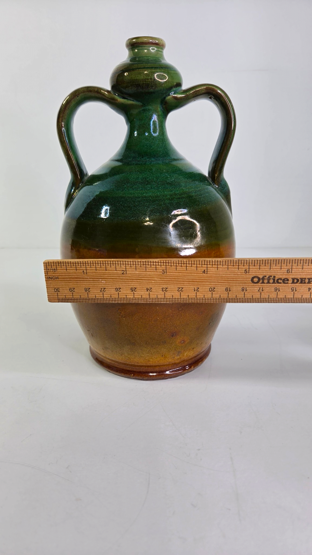 Oddly Darling Vintage handcrafted ceramic jug with dual handles, featuring a forest green and amber-brown glaze.